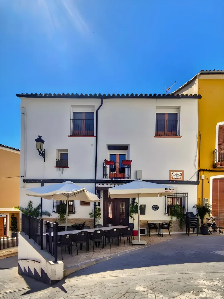 Casa Blanca on the village square, parasols up and the long table set