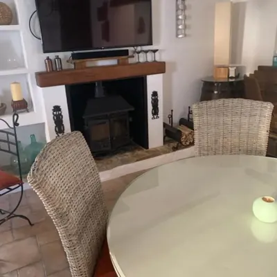 The wood burner below the television, logs stacked ready