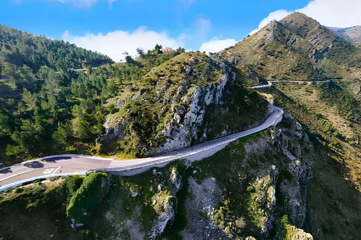 The hairpins of the Coll de Rates road curving along the ridge