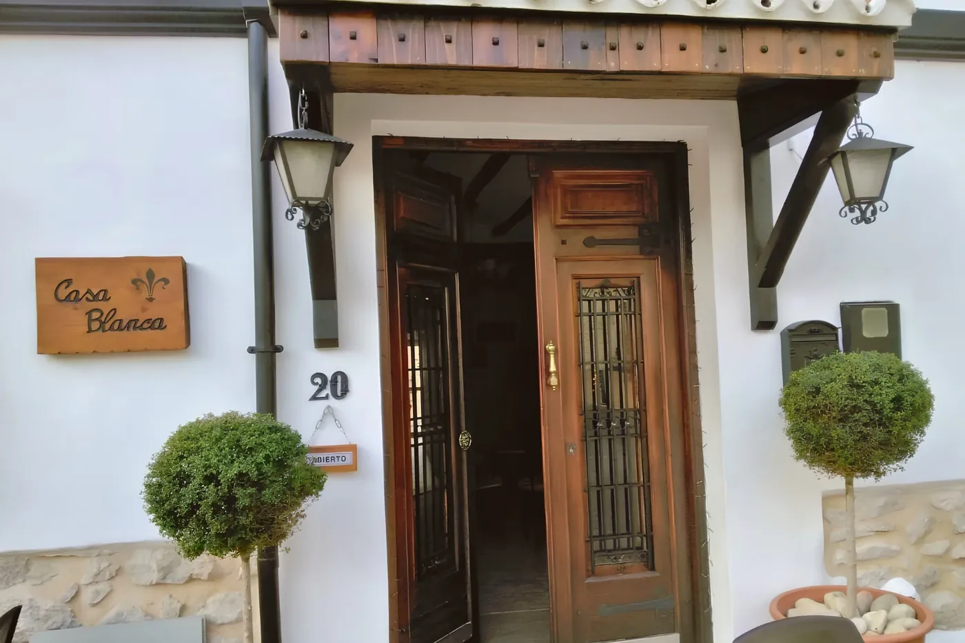 The front door of Casa Blanca on Calle Sant Antonio, doors open, lanterns lit