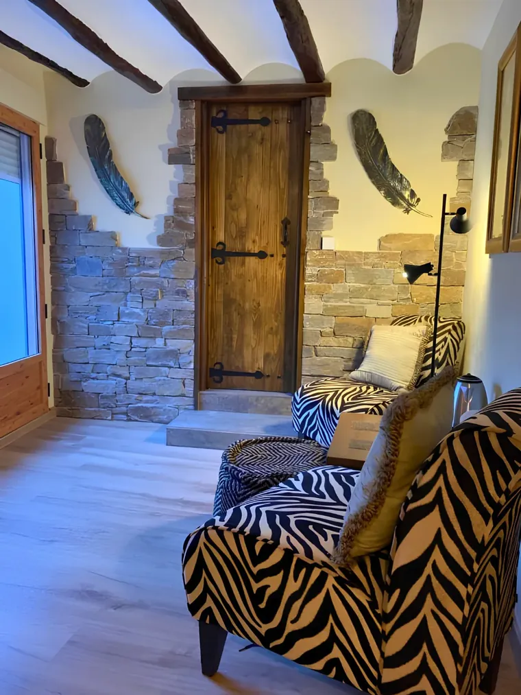 Stone walls, an old timber door and the zebra reading chairs