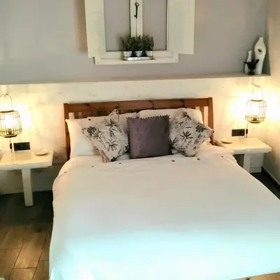 The lantern-lit double bed, made up in white