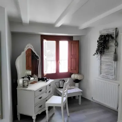 The dressing table by the shuttered window