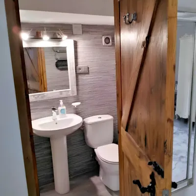 A private bathroom behind its old timber door