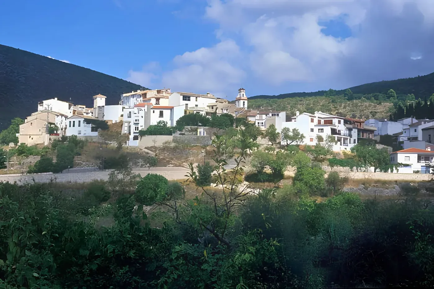 Castell de Castells on its hillside, the bell tower rising above the rooftops