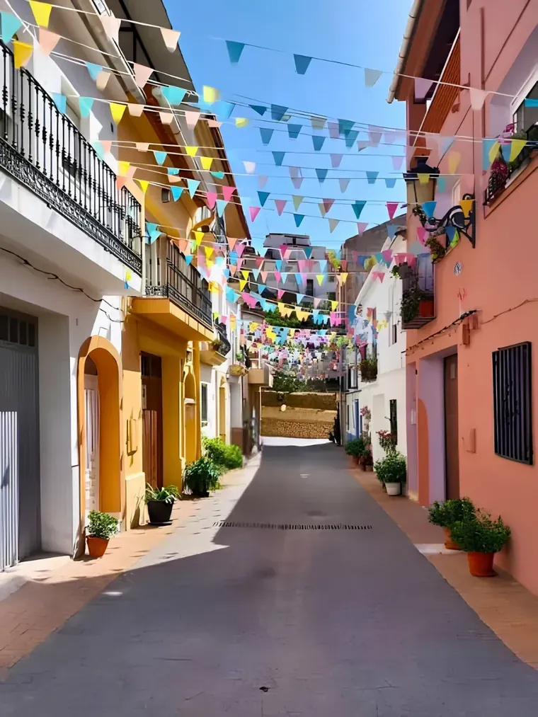 Fiesta bunting across a street in Castell de Castells